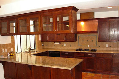 Example of a mid-sized u-shaped terra-cotta tile open concept kitchen design in Cleveland with an undermount sink, shaker cabinets, medium tone wood cabinets, granite countertops, beige backsplash, ceramic backsplash, stainless steel appliances and no island