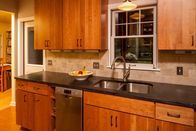 Trendy l-shaped medium tone wood floor eat-in kitchen photo in Detroit with a double-bowl sink, flat-panel cabinets, medium tone wood cabinets, granite countertops, gray backsplash, stainless steel appliances, no island and stone tile backsplash