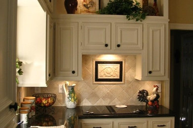Country kitchen photo in Houston with a double-bowl sink, recessed-panel cabinets, white cabinets, granite countertops and beige backsplash