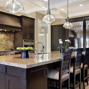Inspiration for a mid-sized tropical u-shaped eat-in kitchen in Phoenix with an integrated sink, recessed-panel cabinets, dark wood cabinets, granite benchtops, multi-coloured splashback, stainless steel appliances, marble floors and with island.