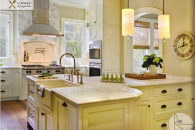 Kitchen - transitional medium tone wood floor kitchen idea in Charleston with a farmhouse sink, beaded inset cabinets, white cabinets, marble countertops, white backsplash, stone tile backsplash, stainless steel appliances and an island