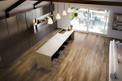 Example of a mid-sized porcelain tile eat-in kitchen design in New York with an island