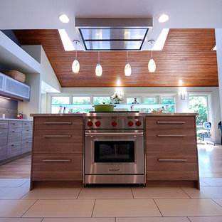 Photo of a mid-sized midcentury u-shaped open plan kitchen in San Francisco with an undermount sink, flat-panel cabinets, medium wood cabinets, zinc benchtops, brown splashback, ceramic splashback, stainless steel appliances, ceramic floors, with island and beige floor.
