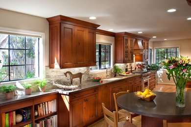 Example of a large classic light wood floor eat-in kitchen design in San Francisco with an integrated sink, recessed-panel cabinets, dark wood cabinets, gray backsplash, stainless steel appliances and an island