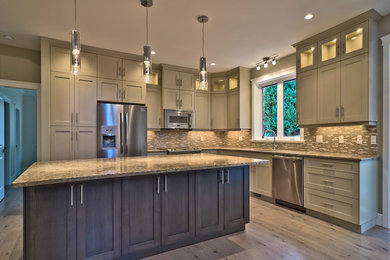 Eat-in kitchen - traditional l-shaped eat-in kitchen idea in Vancouver with an undermount sink, shaker cabinets, gray cabinets, granite countertops, multicolored backsplash and stainless steel appliances