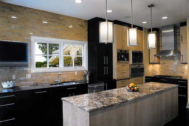 Eat-in kitchen - large contemporary l-shaped eat-in kitchen idea in Cleveland with an undermount sink, flat-panel cabinets, black cabinets, granite countertops, beige backsplash, subway tile backsplash, stainless steel appliances and an island