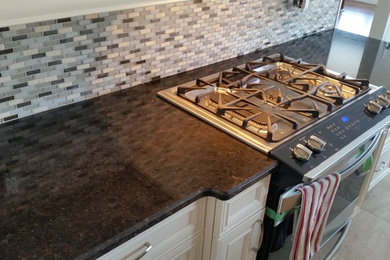 Example of a kitchen design in Toronto with granite countertops