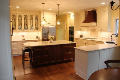 Example of a mid-sized classic light wood floor eat-in kitchen design in Charlotte with a single-bowl sink, white cabinets, quartzite countertops, stone tile backsplash, stainless steel appliances and an island