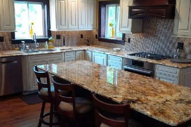 Example of a large classic l-shaped eat-in kitchen design in Other with beige cabinets, granite countertops, multicolored backsplash and an island