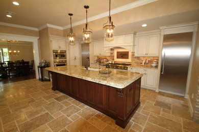 Inspiration for a mid-sized transitional l-shaped eat-in kitchen remodel in Orlando with an undermount sink, raised-panel cabinets, white cabinets, granite countertops, beige backsplash, brick backsplash, stainless steel appliances and an island