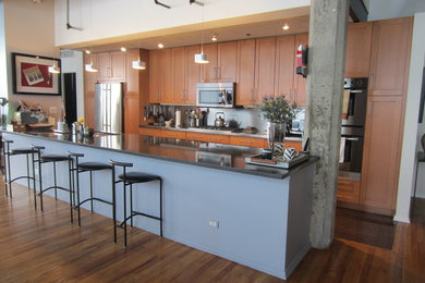 Contemporary kitchen in Baltimore with metal splashback, stainless steel appliances and medium hardwood flooring.