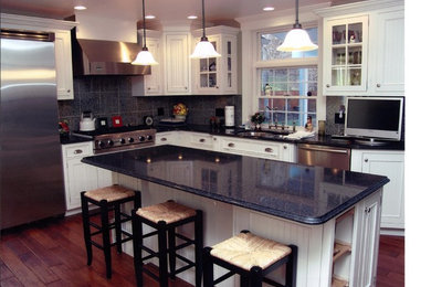 Mid-sized transitional l-shaped dark wood floor eat-in kitchen photo in Other with a drop-in sink, beaded inset cabinets, white cabinets, granite countertops, gray backsplash, stone tile backsplash, stainless steel appliances and an island