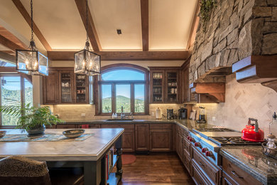 Example of a large mountain style dark wood floor eat-in kitchen design in Denver with stainless steel appliances and an island