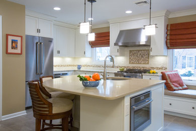 Example of a mid-sized transitional l-shaped porcelain tile kitchen pantry design in Other with an undermount sink, white cabinets, quartz countertops, ceramic backsplash, stainless steel appliances, an island, flat-panel cabinets, beige backsplash and beige countertops
