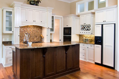 Open concept kitchen - mid-sized transitional l-shaped dark wood floor and brown floor open concept kitchen idea in Orange County with shaker cabinets, white cabinets, granite countertops, brown backsplash, mosaic tile backsplash, paneled appliances and an island