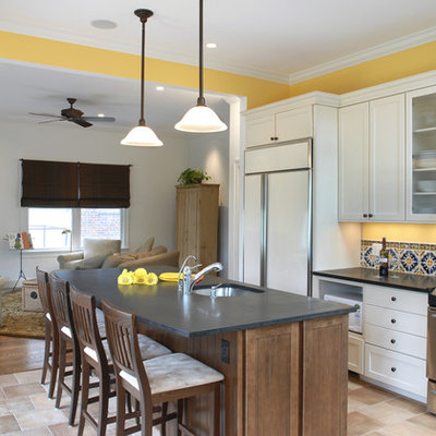 Open concept kitchen - large eclectic l-shaped travertine floor and beige floor open concept kitchen idea in DC Metro with paneled appliances, an undermount sink, shaker cabinets, white cabinets, soapstone countertops, multicolored backsplash, porcelain backsplash and an island