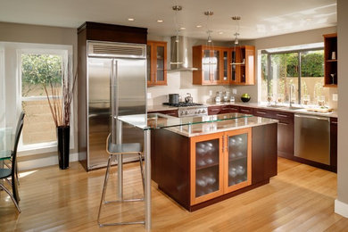 Example of a large trendy u-shaped porcelain tile eat-in kitchen design in Sacramento with recessed-panel cabinets, light wood cabinets, soapstone countertops, multicolored backsplash, mosaic tile backsplash, stainless steel appliances and an island