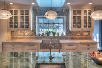 Example of a large classic u-shaped eat-in kitchen design in Chicago with a farmhouse sink, recessed-panel cabinets, beige cabinets, granite countertops, multicolored backsplash and an island