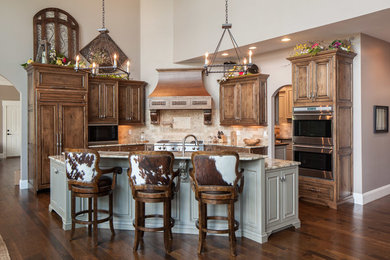 Enclosed kitchen - mid-sized rustic l-shaped medium tone wood floor enclosed kitchen idea in Other with an undermount sink, glass-front cabinets, beige cabinets, solid surface countertops, gray backsplash, marble backsplash, stainless steel appliances and no island