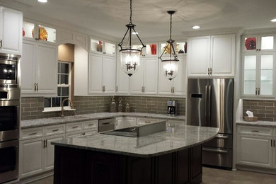 Large transitional l-shaped ceramic tile eat-in kitchen photo in Charlotte with raised-panel cabinets, white cabinets, granite countertops, subway tile backsplash, stainless steel appliances, an island, an undermount sink and beige backsplash
