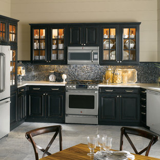 Photo of a mid-sized contemporary u-shaped separate kitchen in New York with an undermount sink, raised-panel cabinets, black cabinets, quartzite benchtops, black splashback, stone tile splashback, stainless steel appliances and marble floors.