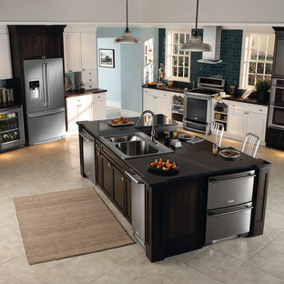 Mid-sized transitional open plan kitchen in Bridgeport with a drop-in sink, shaker cabinets, black cabinets, granite benchtops, black splashback, subway tile splashback, stainless steel appliances, limestone floors and with island.