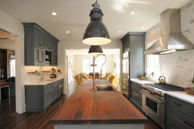 Example of a large country single-wall dark wood floor eat-in kitchen design in Nashville with an undermount sink, recessed-panel cabinets, gray cabinets, wood countertops, gray backsplash, marble backsplash, stainless steel appliances and an island