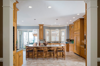 Open concept kitchen - large transitional l-shaped porcelain tile and brown floor open concept kitchen idea in Atlanta with an undermount sink, flat-panel cabinets, light wood cabinets, quartzite countertops, brown backsplash, slate backsplash, paneled appliances and an island