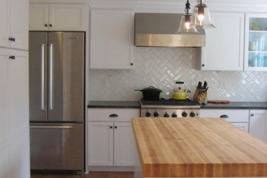 Example of a large transitional single-wall medium tone wood floor open concept kitchen design in San Francisco with an undermount sink, shaker cabinets, white cabinets, quartz countertops, white backsplash, subway tile backsplash, stainless steel appliances and an island