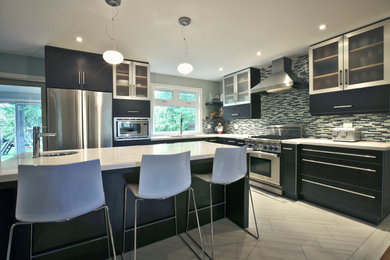 Kitchen - contemporary kitchen idea in Toronto with flat-panel cabinets and an island