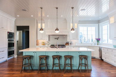 Kitchen - traditional u-shaped dark wood floor kitchen idea in Salt Lake City with shaker cabinets, blue cabinets, white backsplash, stainless steel appliances and an island
