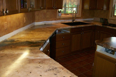 Example of a classic ceramic tile kitchen design in Other with a drop-in sink, brown cabinets, granite countertops, black appliances and an island