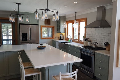 Inspiration for a mid-sized craftsman l-shaped slate floor and brown floor eat-in kitchen remodel in Toronto with a farmhouse sink, shaker cabinets, gray cabinets, quartzite countertops, white backsplash, ceramic backsplash, stainless steel appliances and an island