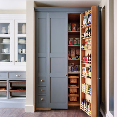 Example of a classic medium tone wood floor kitchen pantry design in London with shaker cabinets and gray cabinets