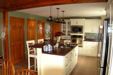 Inspiration for a large l-shaped ceramic tile eat-in kitchen remodel in Providence with shaker cabinets, white cabinets, quartz countertops, stainless steel appliances and an island