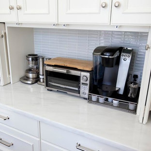 Large transitional open concept kitchen remodeling - Large transitional l-shaped dark wood floor and brown floor open concept kitchen photo in New York with an undermount sink, shaker cabinets, white cabinets, marble countertops, gray backsplash, ceramic backsplash, stainless steel appliances and an island