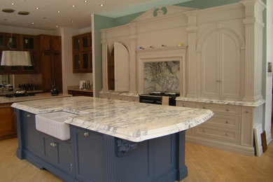 Photo of a classic kitchen/diner in Manchester with a double-bowl sink and marble worktops.