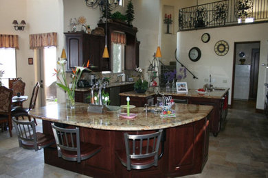 Example of a mid-sized classic ceramic tile and beige floor eat-in kitchen design in San Diego with raised-panel cabinets, medium tone wood cabinets, granite countertops, beige backsplash and two islands