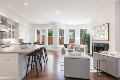 Open concept kitchen - mid-sized transitional l-shaped medium tone wood floor open concept kitchen idea in San Francisco with an undermount sink, shaker cabinets, white cabinets, granite countertops, gray backsplash, porcelain backsplash, stainless steel appliances and an island