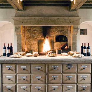 Huge mediterranean eat-in kitchen photos - Huge tuscan u-shaped limestone floor eat-in kitchen photo in New York with a double-bowl sink, shaker cabinets, distressed cabinets, limestone countertops, beige backsplash, stone tile backsplash, an island and paneled appliances