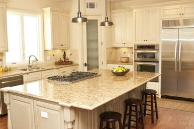 Example of a large classic l-shaped medium tone wood floor and brown floor eat-in kitchen design in Other with a double-bowl sink, raised-panel cabinets, white cabinets, granite countertops, beige backsplash, ceramic backsplash, stainless steel appliances and an island