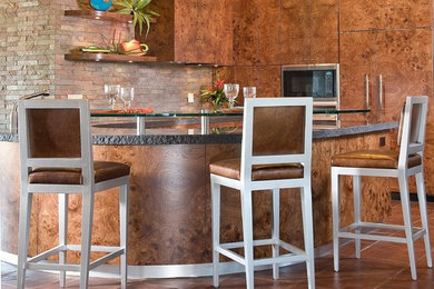 Inspiration for a small contemporary u-shaped terra-cotta tile and brown floor eat-in kitchen remodel in Phoenix with flat-panel cabinets, medium tone wood cabinets, granite countertops, brown backsplash, stone tile backsplash, paneled appliances and a peninsula