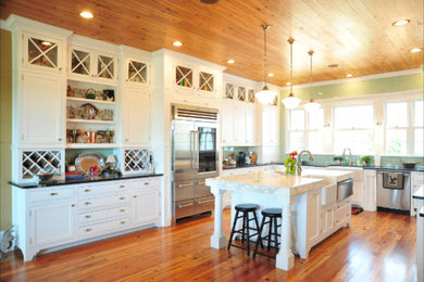 Inspiration for a large country u-shaped dark wood floor and brown floor open concept kitchen remodel in Atlanta with shaker cabinets, white cabinets, an island, a farmhouse sink, soapstone countertops, green backsplash, porcelain backsplash and stainless steel appliances
