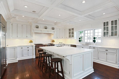Eat-in kitchen - large transitional u-shaped dark wood floor eat-in kitchen idea in New York with marble countertops, white backsplash, white cabinets, subway tile backsplash, stainless steel appliances, an undermount sink, shaker cabinets and an island