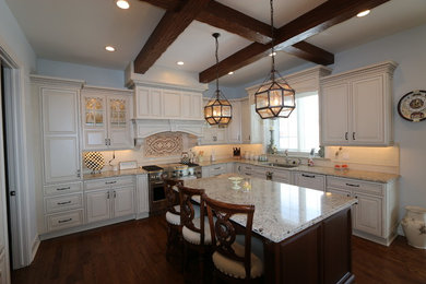 Example of a mid-sized transitional l-shaped medium tone wood floor eat-in kitchen design in Detroit with a double-bowl sink, beige cabinets, quartzite countertops, beige backsplash, stainless steel appliances and an island