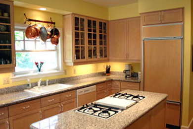 Example of a medium tone wood floor kitchen design in Portland with an island