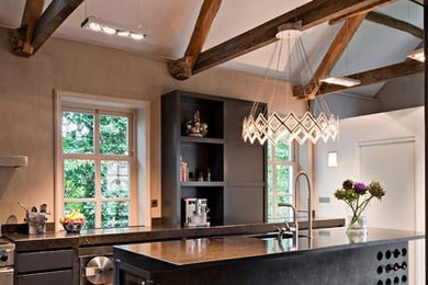 Inspiration for a large traditional single-wall enclosed kitchen in Other with a submerged sink, flat-panel cabinets, black cabinets, onyx worktops, stainless steel appliances, ceramic flooring and an island.