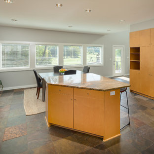 Inspiration for a large modern u-shaped eat-in kitchen in Nashville with a double-bowl sink, flat-panel cabinets, light wood cabinets, granite benchtops, metallic splashback, glass tile splashback, stainless steel appliances, ceramic floors, with island, brown floor and orange benchtop.