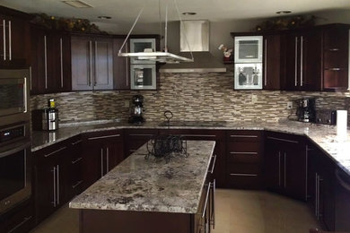 Large elegant u-shaped ceramic tile kitchen photo in Phoenix with a drop-in sink, raised-panel cabinets, dark wood cabinets, granite countertops, multicolored backsplash, stainless steel appliances and an island