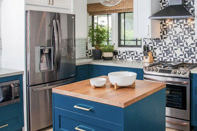 Example of a mid-sized trendy u-shaped light wood floor and beige floor enclosed kitchen design in Los Angeles with an undermount sink, shaker cabinets, blue cabinets, quartz countertops, multicolored backsplash, cement tile backsplash, stainless steel appliances, an island and gray countertops